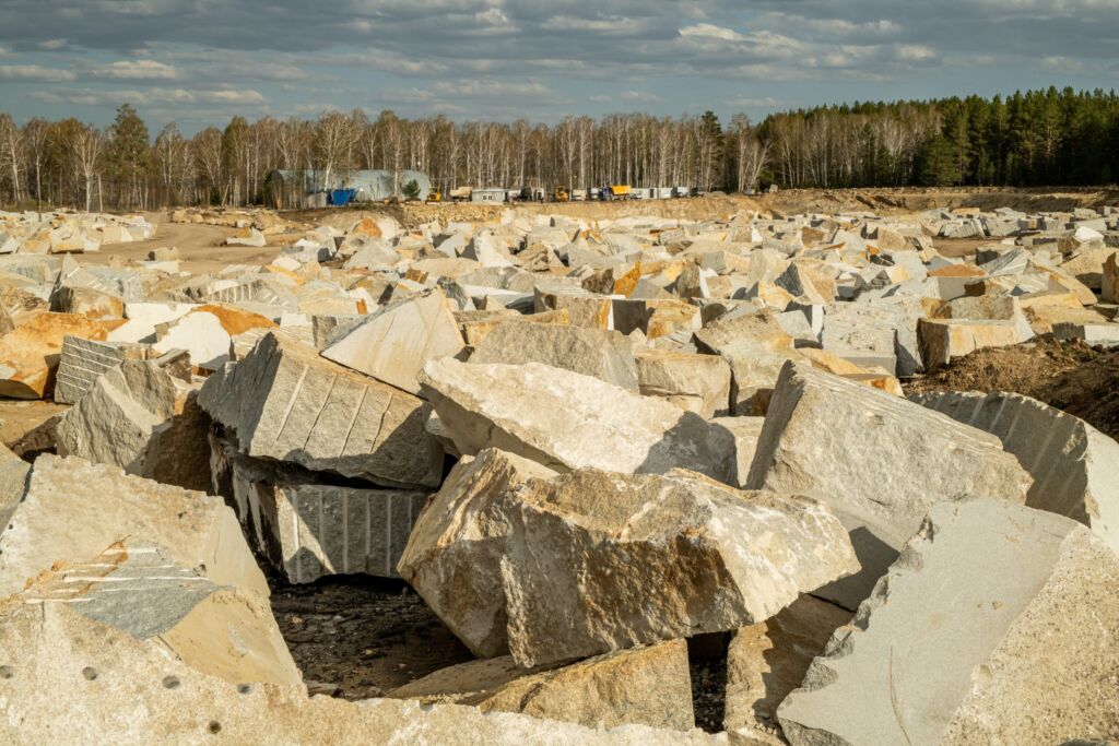 Huge Stones Or Pieces Of Rocks At Quarry Or Construction Site In Natural Environment