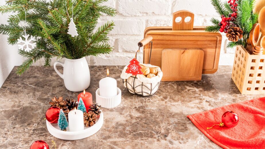 Part Of A Marble Countertop In The Kitchen With A Bouquet Of Spruce Branches, A Tray With Burning Candles, Decorations For The New Year And Christmas