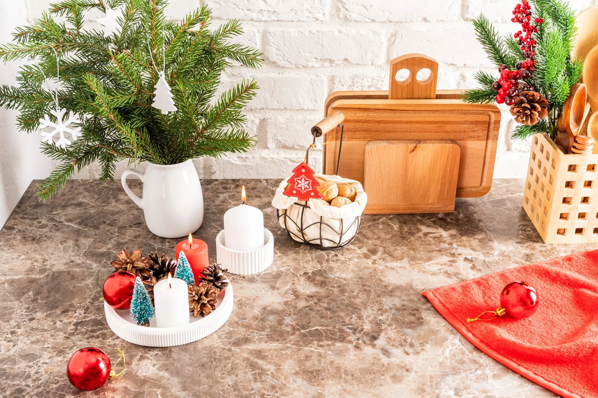 Part Of A Marble Countertop In The Kitchen With A Bouquet Of Spruce Branches, A Tray With Burning Candles, Decorations For The New Year And Christmas