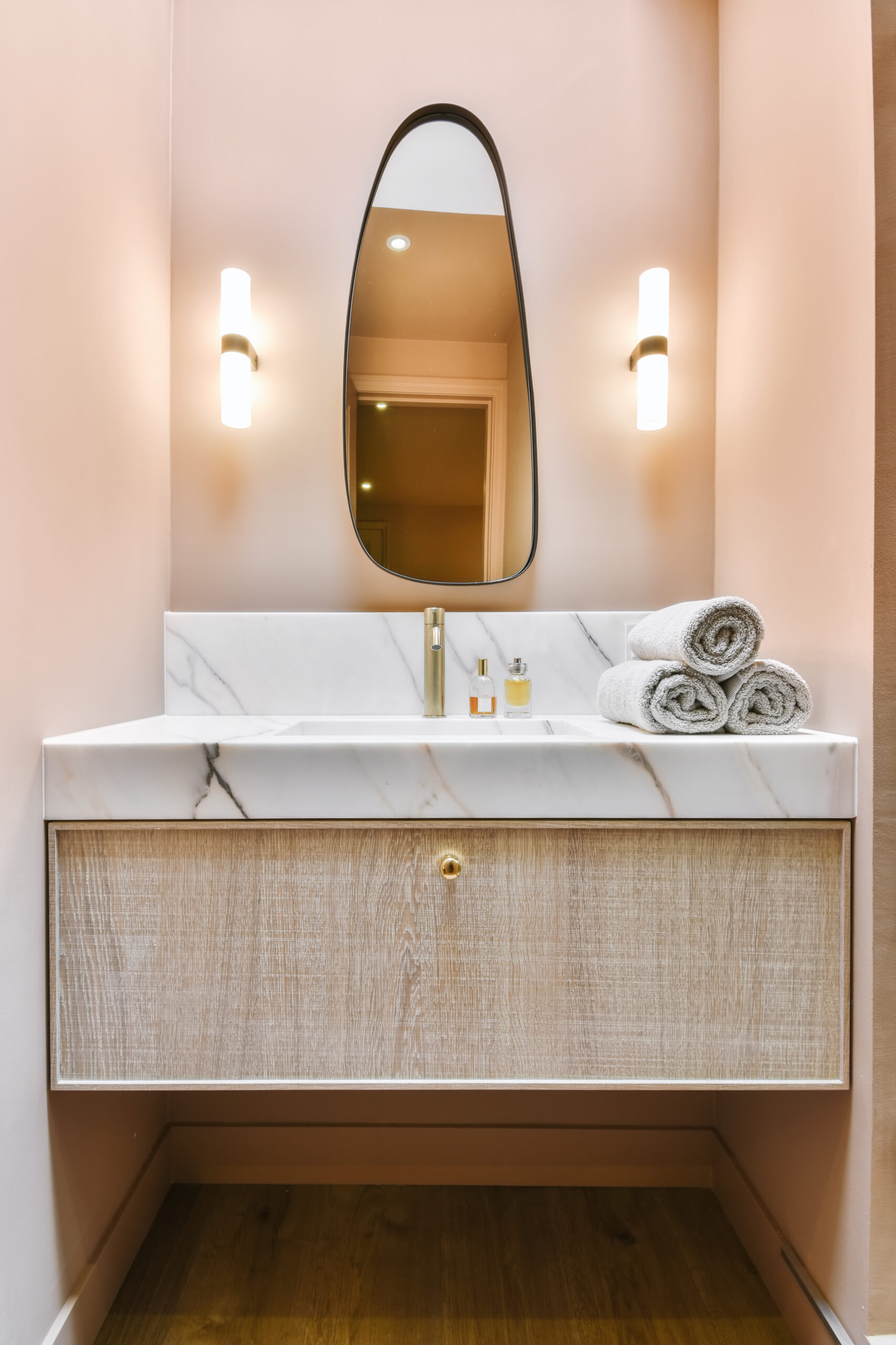 luxurious washroom with peach walls and marble top