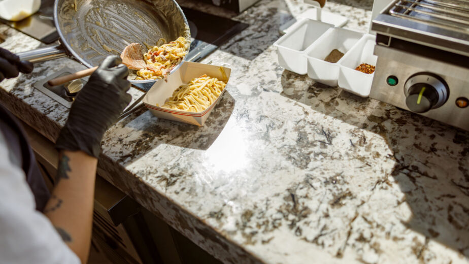 Talented Chef Skillfully Preparing A Delicious Meal On A Beautiful Granite Countertop